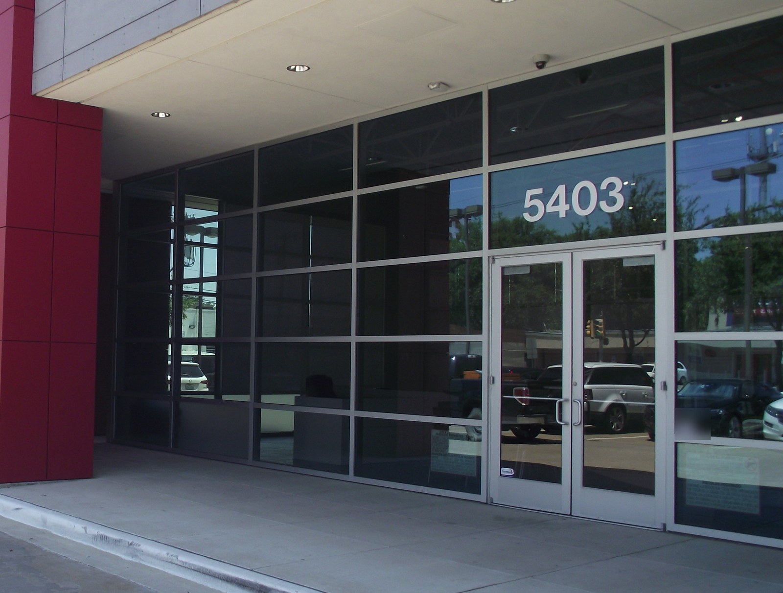 Aluminum storefront entrance beneath a canopy.